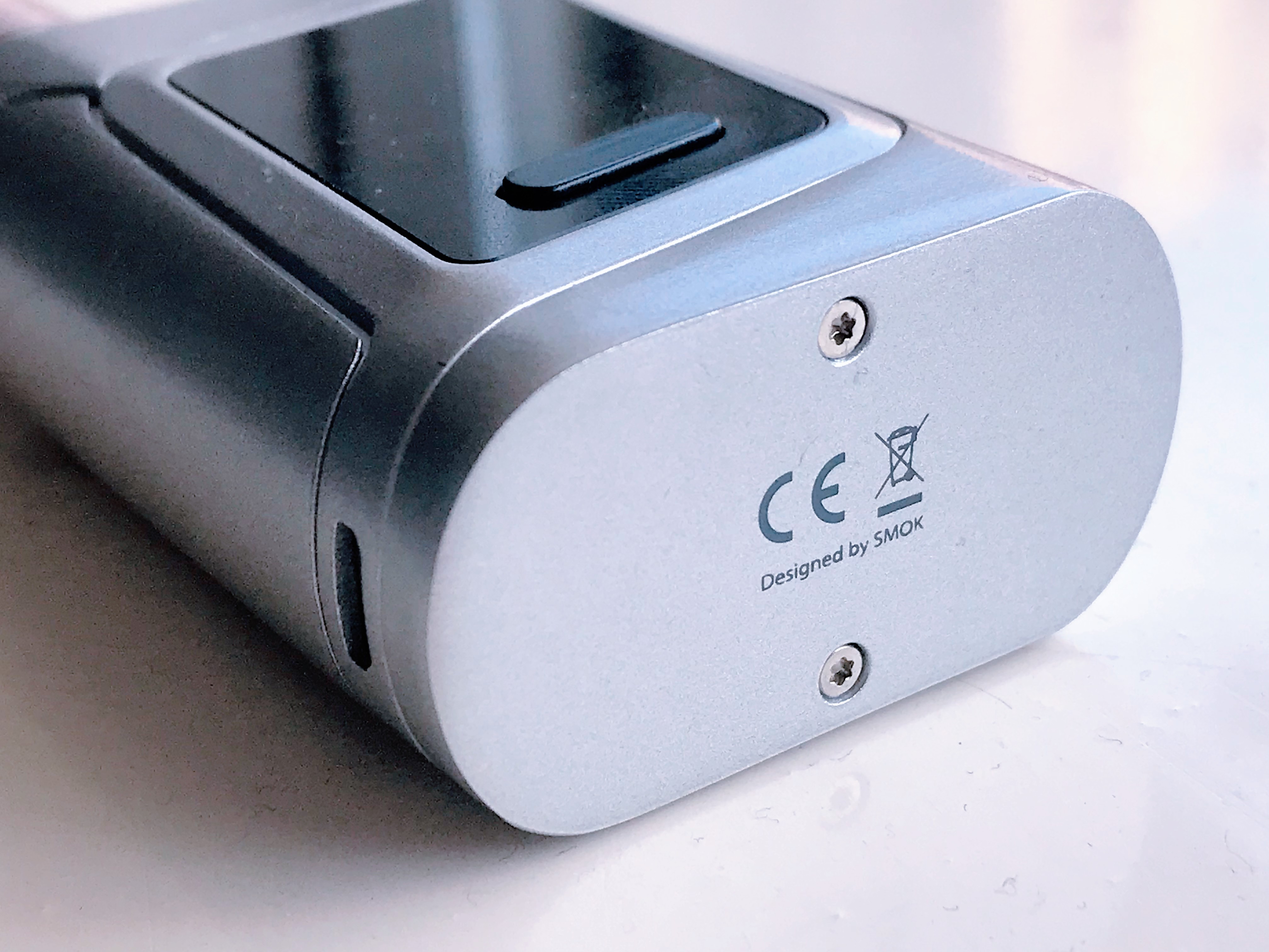 The end face of a metal device casing carrying the CE letters and a crossed-out wheelie bin symbol